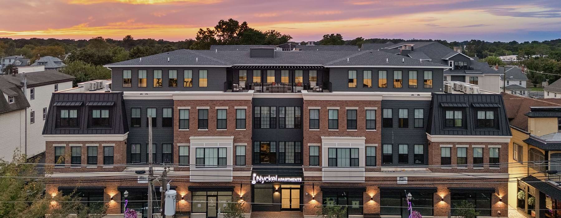 the exterior of a building under a sunset