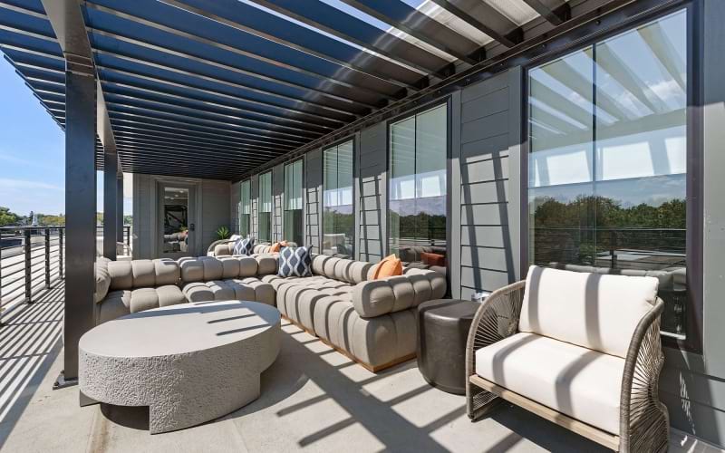 a rooftop patio with couches and chairs