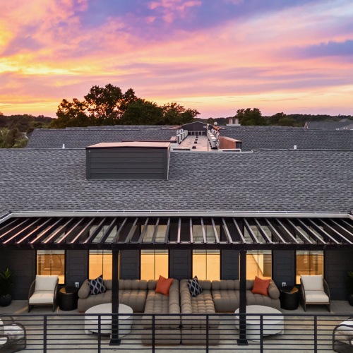 a rooftop area with couches and pillows