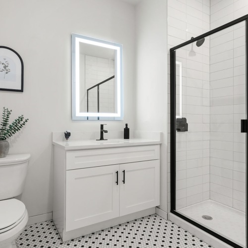 a spacious bathroom with a large mirror and ample light