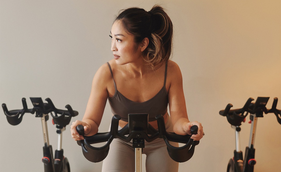 a woman riding a stationary bike